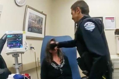 Ters kelepçeli kadına yumruk kamerada!